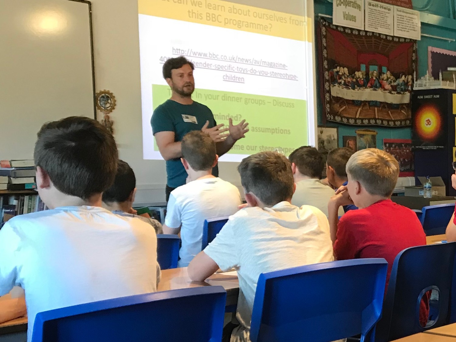 A man is teaching young people in a classroom