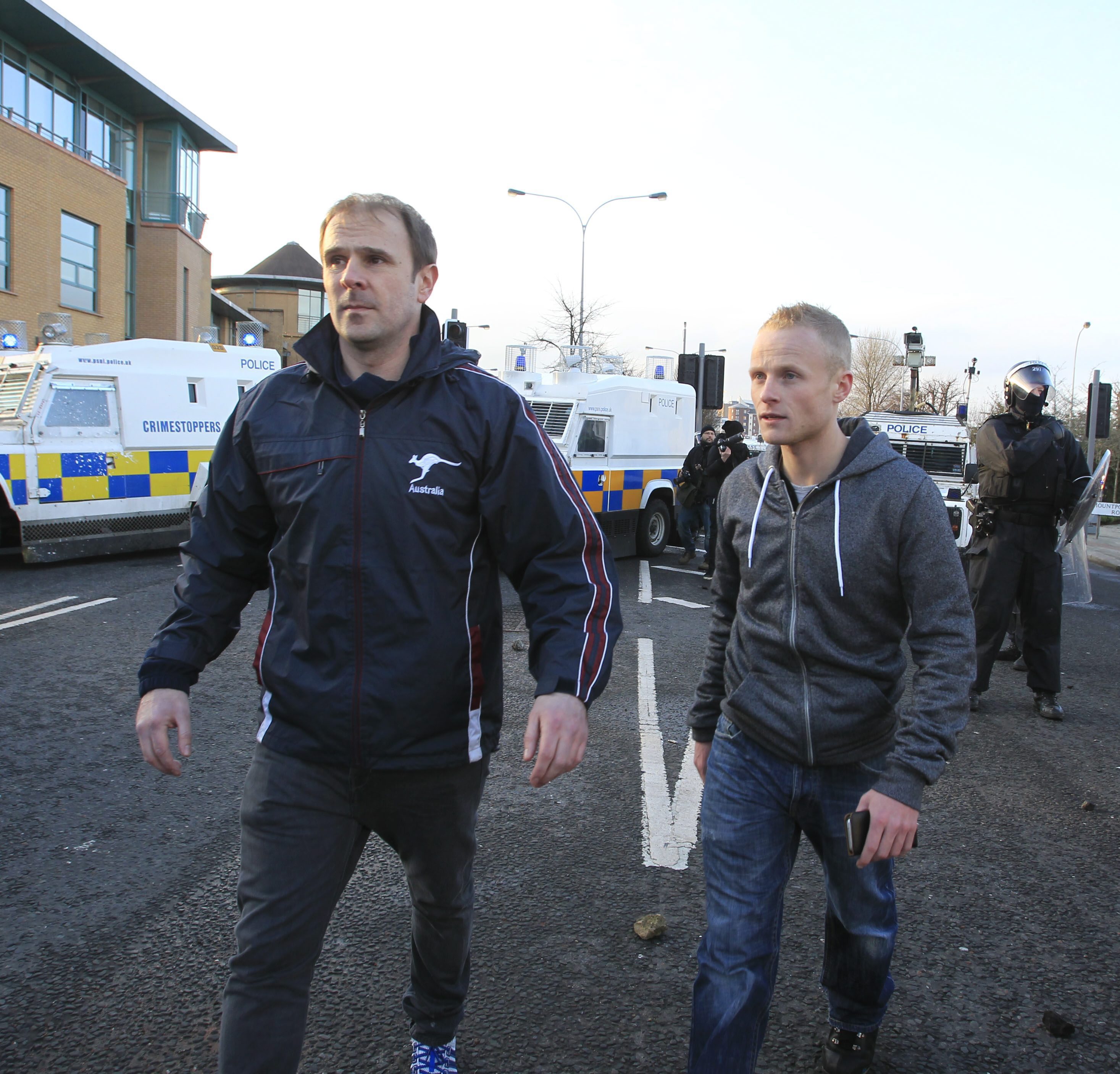 Loyalist Winky Irvine a member of the Unionist forum and Jamie Byrson of the Ulster People forum try to calm the violence.