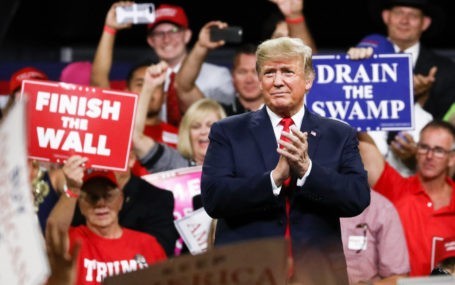 Former President Donald Trump standing behind at a Make America Great Again rally in Johnson City, Tenn., on Oct. 1, 2018.