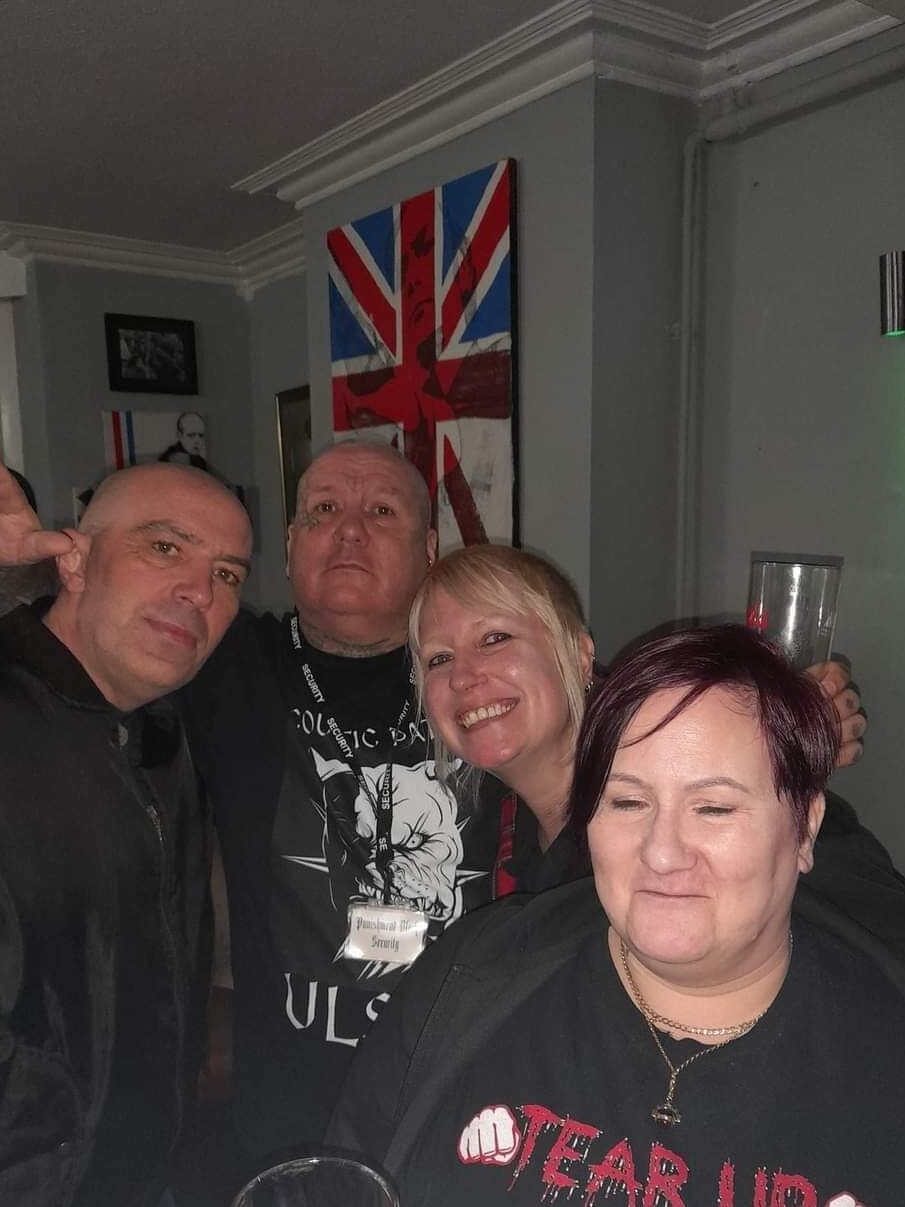 Nazi gig organiser Chad pictured doing the nazi salute whilst stood next to people